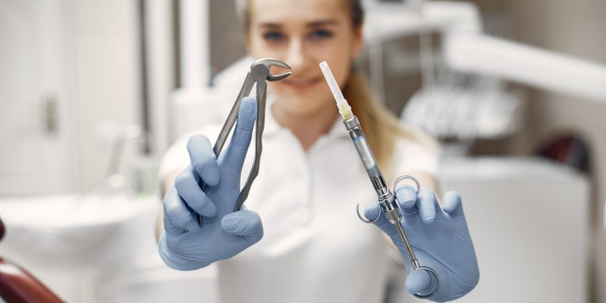 dentist-is-preparing-reception-doctor-with-his-tool-woman-looking-camera-min